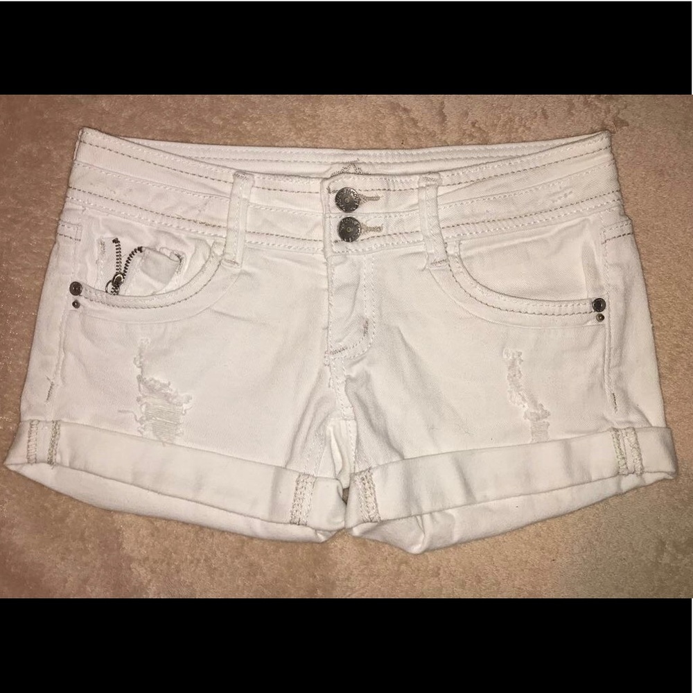 White jean shorts with rips.